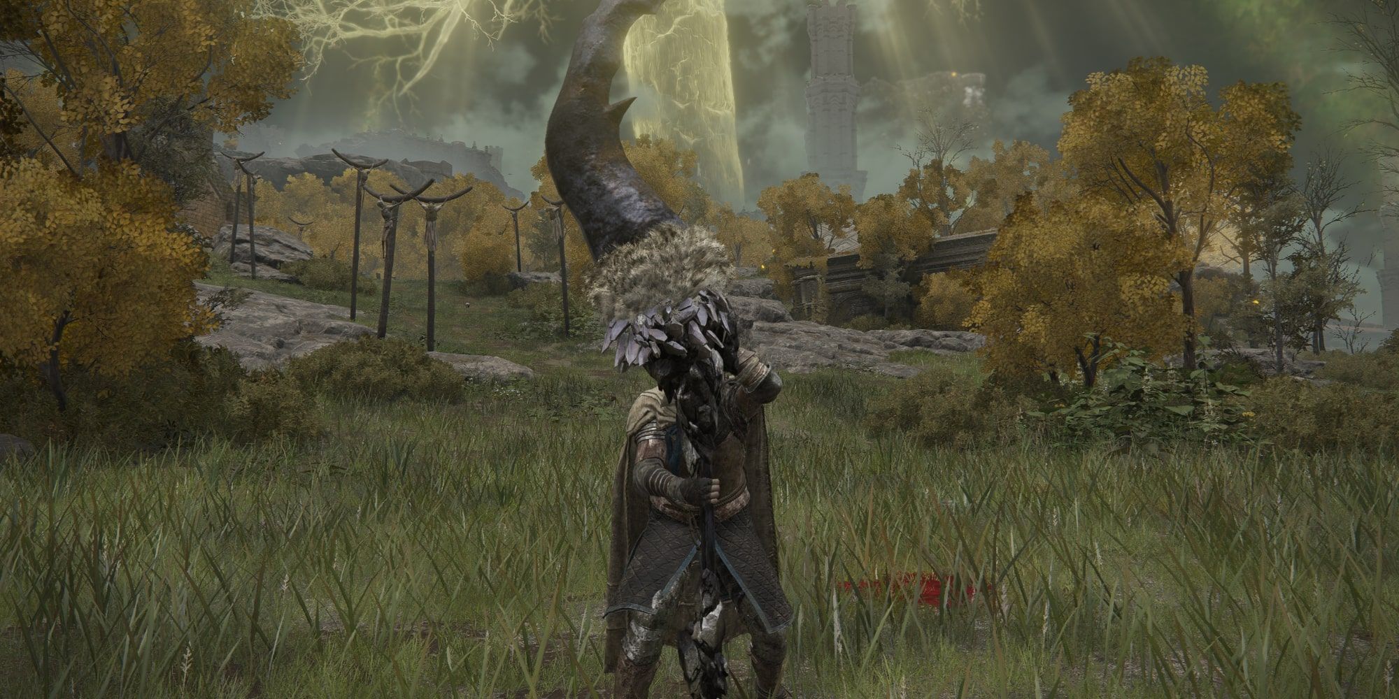 The Tarnished in a field holding the Fallingstar Beast Jaw in Elden Ring.